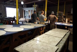 owner and employees preparing a large granite order