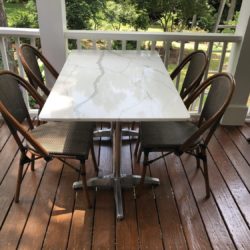calcutta quartz patio table with textiline bistro chairs