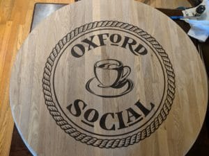 custom logo for oxford social on natural oak butcher block top
